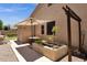 View of home exterior with patio, shade umbrella, garden, and landscaping at 2069 E Winchester Way, Chandler, AZ 85286