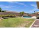 Aerial view of backyard featuring pool, rock waterfall, and green lawn at 2069 E Winchester Way, Chandler, AZ 85286