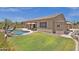 Spacious backyard with green lawn and pool, perfect for outdoor entertaining at 2069 E Winchester Way, Chandler, AZ 85286