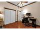 Bedroom featuring a ceiling fan, closet with sliding doors and wood flooring at 2069 E Winchester Way, Chandler, AZ 85286