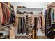 Walk-in closet with shelves and hanging rods for ample storage at 2069 E Winchester Way, Chandler, AZ 85286