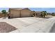 Wide driveway leading to a two-car garage, showcasing desert landscaping and palm trees at 2069 E Winchester Way, Chandler, AZ 85286
