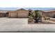 Single-story home with two-car garage and landscaped front yard with desert plants at 2069 E Winchester Way, Chandler, AZ 85286