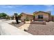 Charming single-story home with desert landscaping, stone walkway and two-car garage at 2069 E Winchester Way, Chandler, AZ 85286