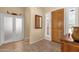 Foyer featuring wood-look tile, coat closet, mirror, and decorative accents that enhance the home's entrance at 2069 E Winchester Way, Chandler, AZ 85286