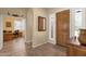 Foyer features decorative mirror, wood floors, front door with sidelight, and a hallway leading to the living spaces at 2069 E Winchester Way, Chandler, AZ 85286