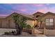 Inviting single-story home boasting desert landscaping, walkway, and warm exterior lighting at 2069 E Winchester Way, Chandler, AZ 85286