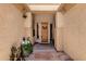 Inviting front porch featuring stone flooring, decorative plants, and a charming wood front door with wreath at 2069 E Winchester Way, Chandler, AZ 85286