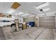 Spacious three car garage with storage cabinets, overhead lighting and three garage doors at 2069 E Winchester Way, Chandler, AZ 85286