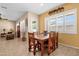 Spacious kitchen nook featuring a wooden table with seating for six, tile floors, and large bright windows at 2069 E Winchester Way, Chandler, AZ 85286