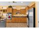 Spacious kitchen featuring wood cabinets, stainless steel appliances, granite countertops, and tile floors at 2069 E Winchester Way, Chandler, AZ 85286