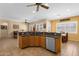 Open concept kitchen featuring wood cabinets, stainless steel appliances, granite countertops, and tile floors at 2069 E Winchester Way, Chandler, AZ 85286