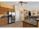 Bright kitchen featuring wood cabinets, stainless steel appliances, granite countertops, and tile floors at 2069 E Winchester Way, Chandler, AZ 85286