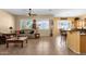 Open-concept living room and kitchen area featuring tile floors, natural light, and ceiling fan at 2069 E Winchester Way, Chandler, AZ 85286