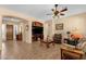 Comfortable living room with tile flooring, neutral walls, a built-in entertainment center, and a ceiling fan at 2069 E Winchester Way, Chandler, AZ 85286