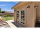 Exterior of backyard outbuilding featuring double doors, lighting, and desert landscaping at 2069 E Winchester Way, Chandler, AZ 85286
