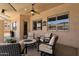 Covered patio space with comfortable seating, overhead lighting and a view of the landscaped backyard at 2069 E Winchester Way, Chandler, AZ 85286