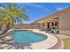 Backyard pool features mature landscaping and a rock feature with small waterfall at 2069 E Winchester Way, Chandler, AZ 85286
