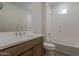 Bright bathroom features a bathtub, a vanity with sink and traditional fixtures, and a linen closet at 2121 W Sonoran Desert Dr # 86, Phoenix, AZ 85085
