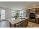 Bright kitchen features a center island with a stainless steel sink and a modern appliance package at 2121 W Sonoran Desert Dr # 86, Phoenix, AZ 85085