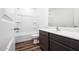 Bathroom with a shower-tub combo, modern vanity, and wood-look flooring at 21999 E Wayward Ln, Red Rock, AZ 85145