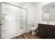 Modern bathroom with a glass-enclosed shower, stylish vanity, and wood-look flooring at 21999 E Wayward Ln, Red Rock, AZ 85145