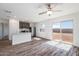 Open-concept living space with wood floors, backyard access, and a modern kitchen at 21999 E Wayward Ln, Red Rock, AZ 85145