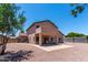 The backyard has a covered patio and tiled area, surrounded by desert landscaping and a block fence at 2213 N Ashbrook Cir, Mesa, AZ 85213