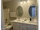 Bathroom featuring double sinks, oval mirrors, white countertops, and decorative wall art at 2213 N Ashbrook Cir, Mesa, AZ 85213