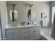 Elegant bathroom with dual vanities, oval mirrors, and pristine white countertops at 2213 N Ashbrook Cir, Mesa, AZ 85213