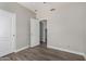 Bedroom with light-colored walls and flooring showcasing an open doorway at 2213 N Ashbrook Cir, Mesa, AZ 85213