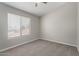 Neutral bedroom with a large window and carpeted flooring at 2213 N Ashbrook Cir, Mesa, AZ 85213