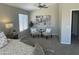 Neutral bedroom with a ceiling fan, sitting area with two chairs, and a window with blinds at 2213 N Ashbrook Cir, Mesa, AZ 85213