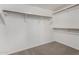 Spacious walk-in closet with ample wooden shelving and carpeted flooring at 2213 N Ashbrook Cir, Mesa, AZ 85213