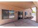 Covered patio featuring a ceiling fan, windows, and sliding glass doors overlooking the backyard at 2213 N Ashbrook Cir, Mesa, AZ 85213