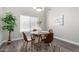 Bright dining area with a round wooden table, modern chairs, and natural light at 2213 N Ashbrook Cir, Mesa, AZ 85213