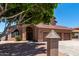 Attractive home featuring an arched entryway, desert landscaping, and a three-car garage at 2213 N Ashbrook Cir, Mesa, AZ 85213