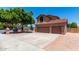 Charming home featuring a three-car garage, tiled roof, and low maintenance landscaping at 2213 N Ashbrook Cir, Mesa, AZ 85213