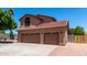 Charming home featuring a three-car garage, tiled roof, and low maintenance landscaping at 2213 N Ashbrook Cir, Mesa, AZ 85213