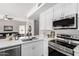 Modern kitchen featuring white cabinets, stainless steel appliances, and an island at 2213 N Ashbrook Cir, Mesa, AZ 85213