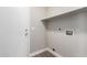 Bright laundry room with white walls, gray floors, a shelf, and utility hookups at 2213 N Ashbrook Cir, Mesa, AZ 85213