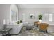 Bright living room with neutral colors, large windows, and modern furniture at 2213 N Ashbrook Cir, Mesa, AZ 85213
