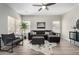 Cozy living room features a dark brown sectional sofa and a decorative cowhide rug at 2213 N Ashbrook Cir, Mesa, AZ 85213
