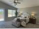 Serene main bedroom with a vaulted ceiling, soft lighting, and sliding glass door to balcony at 2213 N Ashbrook Cir, Mesa, AZ 85213