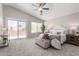 Spacious main bedroom with a ceiling fan, carpet floors and natural light at 2213 N Ashbrook Cir, Mesa, AZ 85213