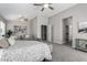 Comfortable main bedroom with a ceiling fan, carpet floors, and natural light at 2213 N Ashbrook Cir, Mesa, AZ 85213