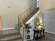Bright staircase with a gray carpet runner and a decorative wrought iron railing at 2213 N Ashbrook Cir, Mesa, AZ 85213