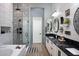 A modern bathroom with black-and-white shower, granite counters, and dual sinks at 26885 N 104Th Pl, Scottsdale, AZ 85262