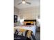 Inviting bedroom features a stylish accent wall, floral bedding, and ambient lighting for a restful and decorative space at 26885 N 104Th Pl, Scottsdale, AZ 85262