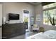 Bedroom featuring neutral colors, textured furnishings, and plenty of natural light from the windows at 26885 N 104Th Pl, Scottsdale, AZ 85262